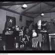 112644 [children receiving gifts while visiting Camp Pell]
